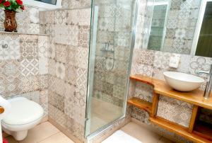 a bathroom with a shower and a toilet and a sink at casa maria in La Romana +15 photos