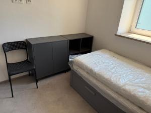 a bedroom with a bed and a desk and a chair at Baumannhaus in Ziemetshausen