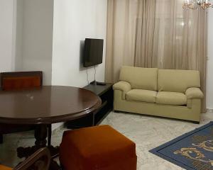 a living room with a couch and a table at Sweet Home in Tunis