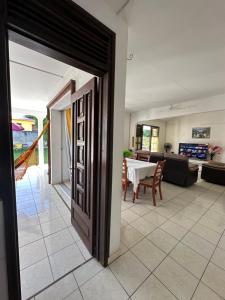 an open door to a living room with a table at Appt Cosy Belcourt in Baie-Mahault