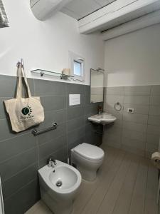 a bathroom with a toilet and a sink and a toilet istg at Soleluna in Syracuse +73 photos