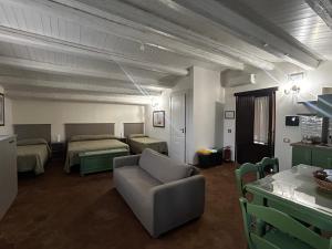 a living room with a couch and two beds at Soleluna in Syracuse