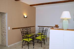 a dining room with a glass table and chairs at domaine de bessilles in Montagnac