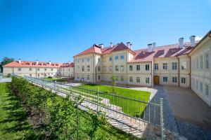 a large building with a fence in front of it at Zámecký Apartmán Verde in Jince