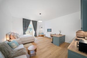 a living room with a couch and a bed at Zámecký Apartmán Verde in Jince