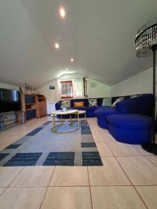 a living room with a blue couch and a table at Milla Sky in Varaždinske Toplice