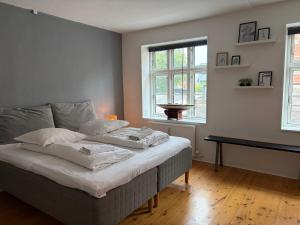 a bedroom with a bed with two pillows on it at Huset ved springvandet in Randers