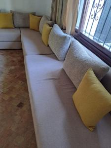 a long couch with pillows on it in a room at Villa Saif in Marina Smir +3 photos