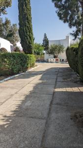 an empty street with trees and a building at Villa Saif in Marina Smir