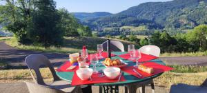 a table with a plate of bread and wine glasses at Gite la Borie de Pourtou Santoire in Condat +3 photos