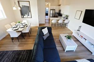 a living room with a couch and a table at Central 3 Queen Beds AC Double Garage Disney in Edmonton