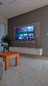 a living room with a large flat screen tv on a wall at Furahi Apartment in Mombasa