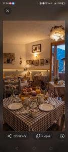 a table with a checkered table cloth on it at Villa Amaranta Room and Breakfast in Edolo
