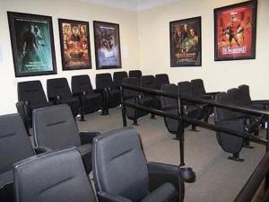 a room with chairs and posters on the wall at Florida Vacation Condo - No Resort Fees in Kissimmee +111 photos