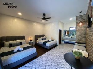 a bedroom with two beds and a living room at Sekepeng Penarek II in Kampung Penarik +18 photos
