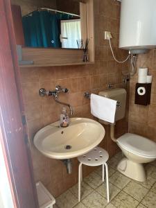 a bathroom with a sink and a toilet at Apartmani Krk in Krk +9 photos