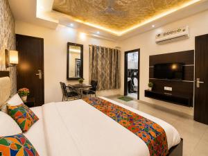 a hotel room with a bed and a television at Hotel Star Grand - Premium Budget Hotel Near Taj mahal, in Agra +18 photos