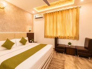 a hotel room with a bed and a chair at Hotel Star Grand - Premium Budget Hotel Near Taj mahal, in Agra