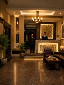 two men in suits standing in a lobby at Hotel Star Grand - Premium Budget Hotel Near Taj mahal, in Agra