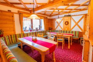 a restaurant with tables and chairs in a room at Minzlhof in Ramsau am Dachstein +27 photos