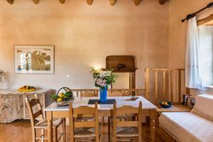 a dining room with a table and chairs at Kamares Private Pool stone Villa in Makhairoí