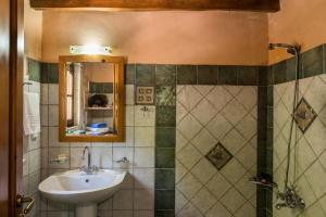 a bathroom with a sink and a mirror at Kamares Private Pool stone Villa in Makhairoí +11 photos