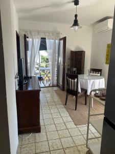 a living room with a table and a tv and a table and chairs at Apartmani Krk in Krk