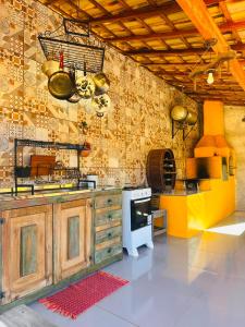 a kitchen with a counter and a stove in a room at Cheiro de Flor - Gamarra in Baependi