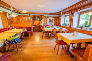 a dining room with tables and chairs in a restaurant at Minzlhof in Ramsau am Dachstein