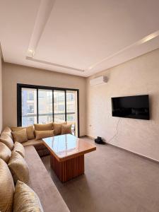 a living room with a couch and a coffee table at Magic House T5 -El Mansouria in Mansouria