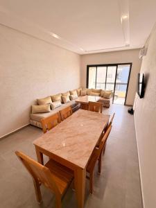 a living room with a table and a couch at Magic House T5 -El Mansouria in Mansouria +1 photo