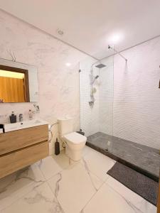 a bathroom with a shower and a toilet and a sink at Magic House T5 -El Mansouria in Mansouria