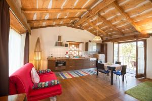 a living room with a red couch and a table at Stonehouse LOFT MARTA in Vergato