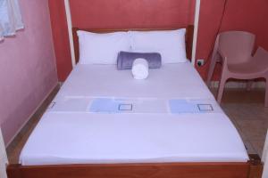 a bed with a roll of toilet paper on it at La Bella resort in Mombasa