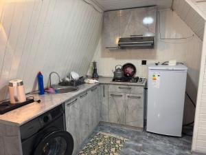 a small kitchen with a sink and a refrigerator at xanagah aframe in Qala