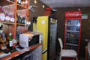a room with an old refrigerator and a microwave at La Bella resort in Mombasa +7 photos