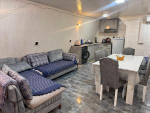 a living room with a couch and a table at xanagah aframe in Qala