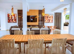 a dining room with a wooden table and chairs at Atlantic Shores Resort in Igbolobi
