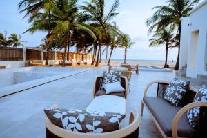 a resort with a swimming pool and palm trees at Atlantic Shores Resort in Igbolobi