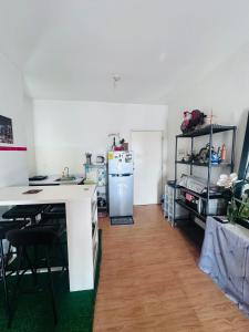 a kitchen with a refrigerator and a table with chairs at Condo unit in Novaliches Quezon City near Caloocan City in Manila