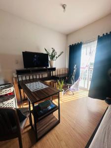 a living room with a table and a couch at Condo unit in Novaliches Quezon City near Caloocan City in Manila