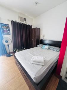 a bedroom with a bed with two towels on it at Condo unit in Novaliches Quezon City near Caloocan City in Manila