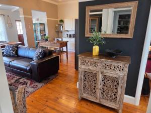 a living room with a couch and a table at Beach Street Self-Catering in Mossel Bay