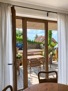 a sliding glass door leading to a patio with a table at Apartament na Wzgórzu in Wieliczka
