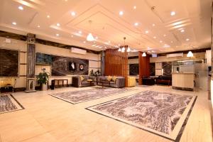 a large living room with a couch and a table at شقق راف التميز in Umm Salam