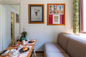 a living room with a table and a couch at Casa DiMì - 2 BR, 2 en-suite bath, 2 min M5, Smart lock in Milan