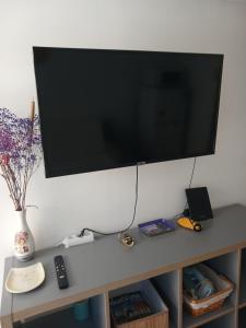 a flat screen tv hanging on a white wall at Mayka in L'Isle-sur-la-Sorgue