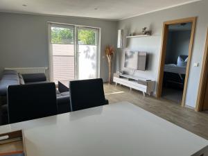 a living room with a couch and a table and a television at Ferienhaus Katja in Göhren