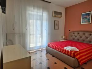 a bedroom with a bed with a red blanket at Casa 2019 in Matera