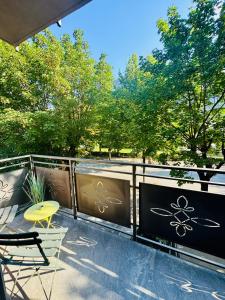 a balcony with a table and chairs and trees at Escape Room 04 in Tirano